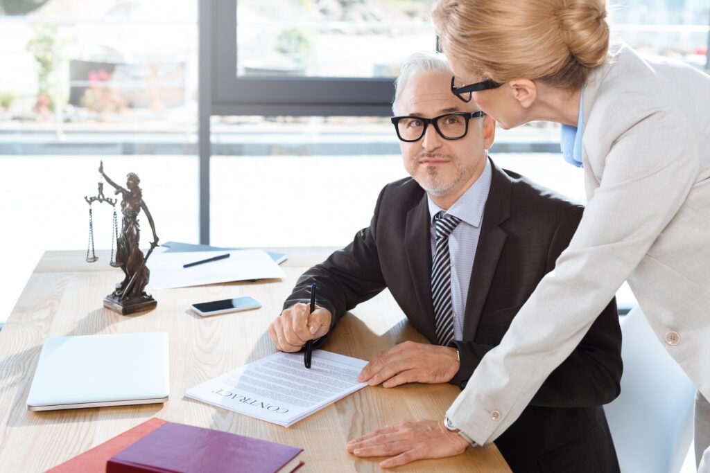 mature lawyers working with contract together